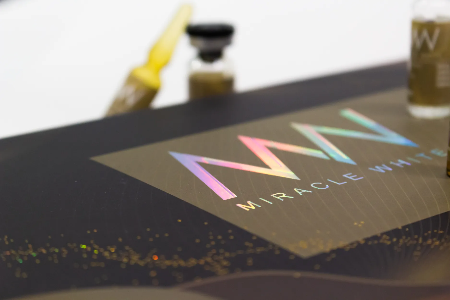 Holographic Miracle White foil mark on the Royal Gold carton